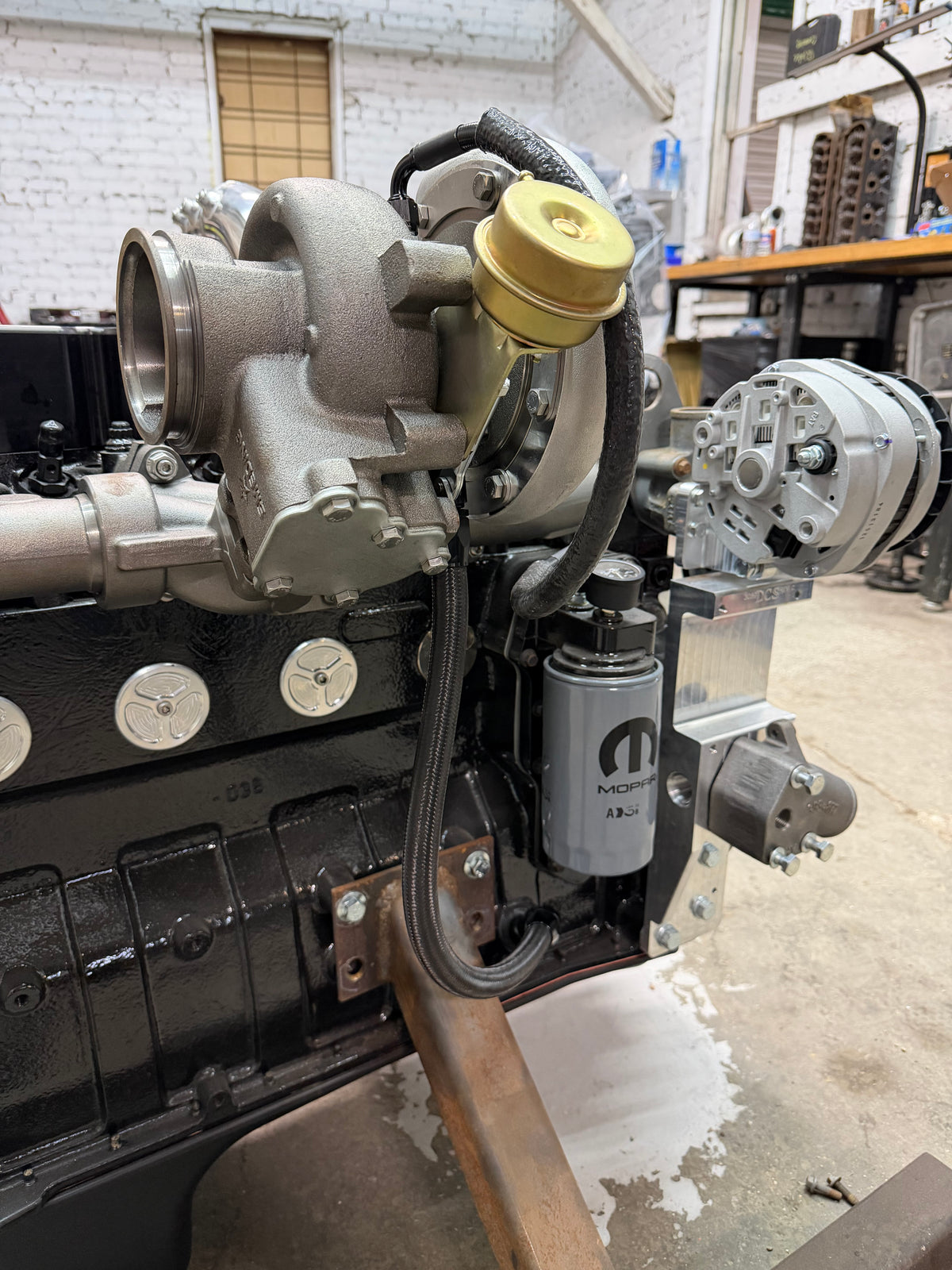 High-mount turbo oil feed line routed on a Cummins in the shop