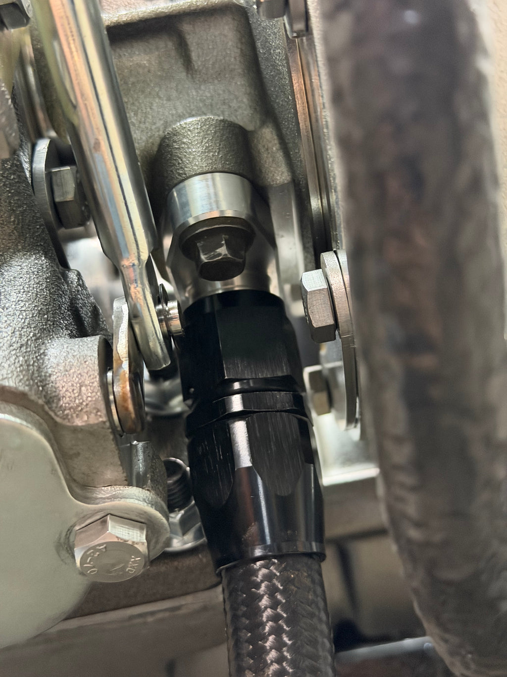 Black -10AN oil drain fitting on the engine block