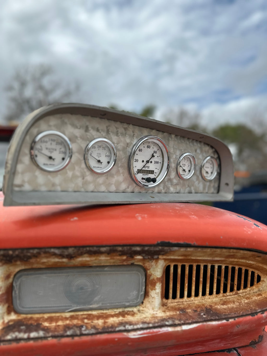 Angled view of the custom bezel and five AutoMeter gauges