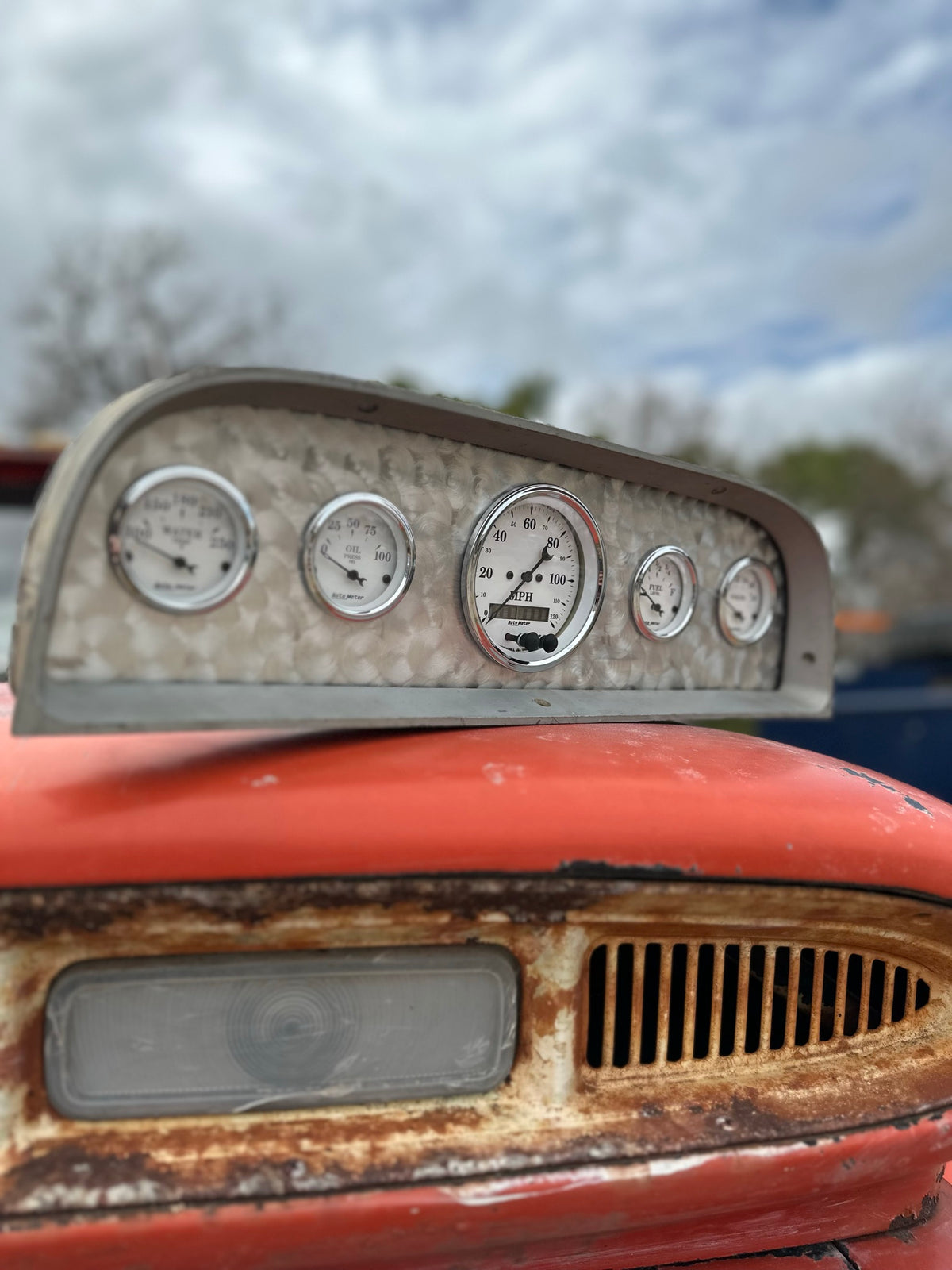 Angled view of the custom bezel and five AutoMeter gauges