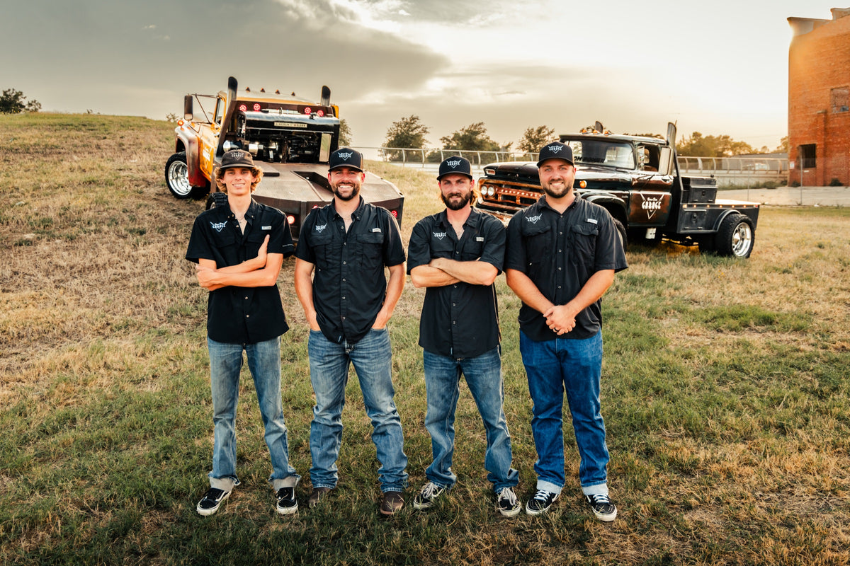 The Brown Bros. Garage crew lined up in front of their trucks