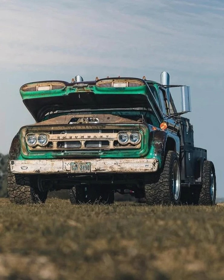Pigpen, a green patina 1960 Chevy C60 Viking, parked in a field