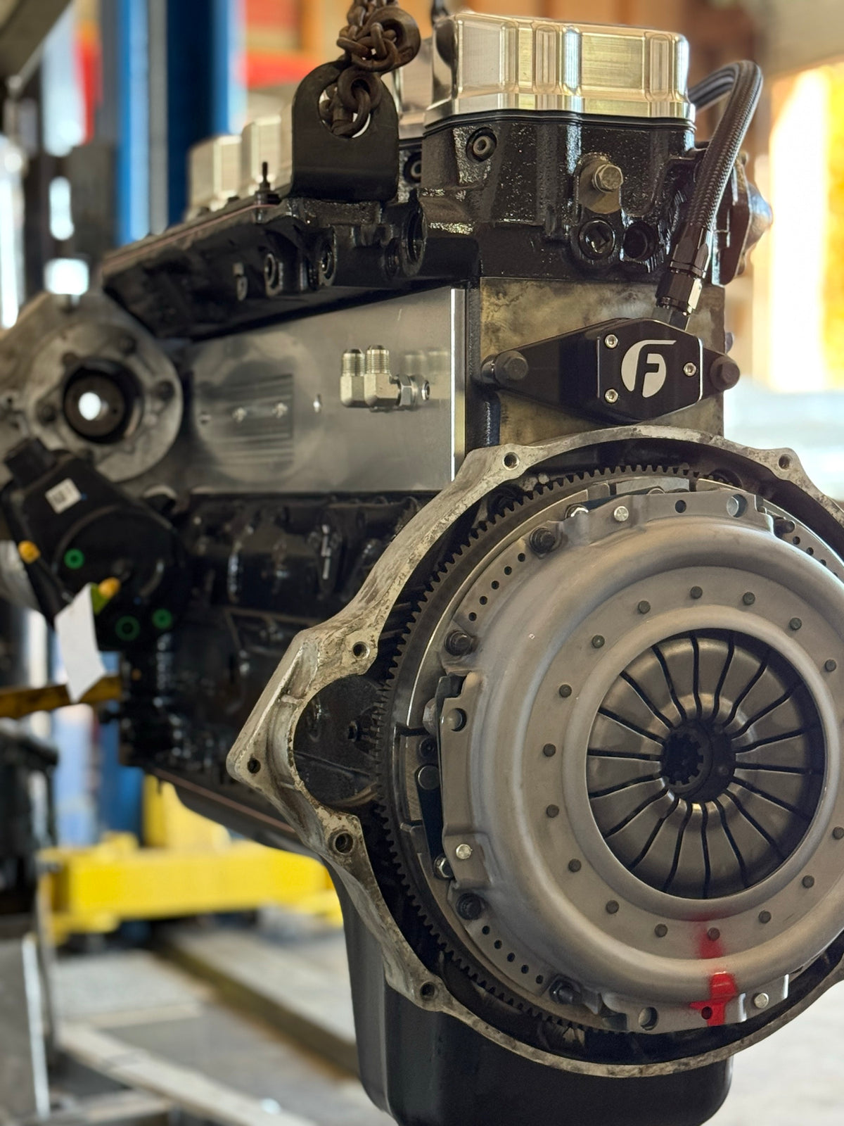 Diesel engine on a stand with the clutch and flywheel installed in the Brown Bros. shop